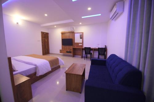 Ένα ή περισσότερα κρεβάτια σε δωμάτιο στο Queen C Inn Wayanad