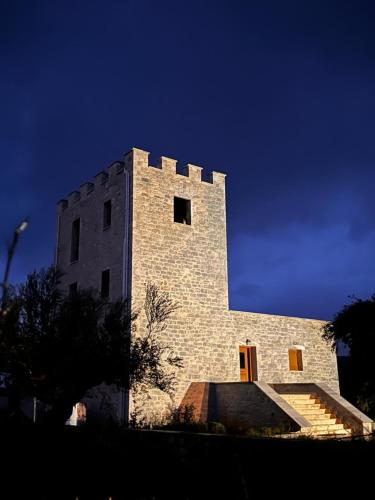 a tall brick building with stairs in front of it at MANI Kamares Beach House in Gythio