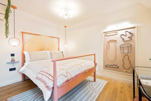 a bedroom with a bed and a painting on the wall at Sea-Glimpse Studio on Seafront in Weymouth