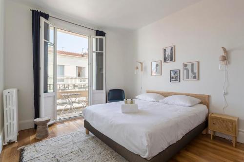 une chambre avec un grand lit et un balcon dans l'établissement Hamac Suites - Suite Crillon, à Lyon