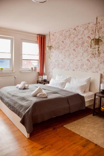 a bedroom with a large bed with two towels on it at KOCHWERK Restaurant & Pension in Zingst