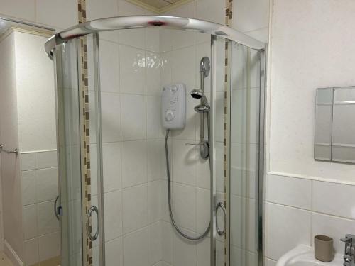 a shower in a bathroom with a glass shower stall at Bute Apartment by Klass Living Coatbridge in Coatbridge