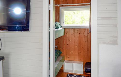 a person taking a picture of a tiny house at Beach Front Home In Straumsjen With Kitchen in Straumsjøen