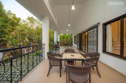 a balcony with a table and chairs on it at Ekostay Luxe - CASA SIA - Ideal for Big Groups- Poker Table in Lonavala