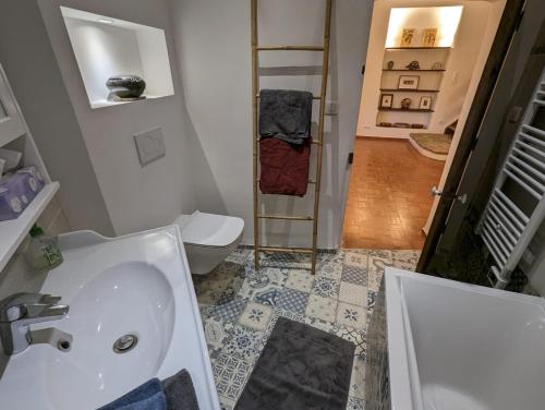 a bathroom with a sink and a toilet at La Brigandine in Bormes-les-Mimosas