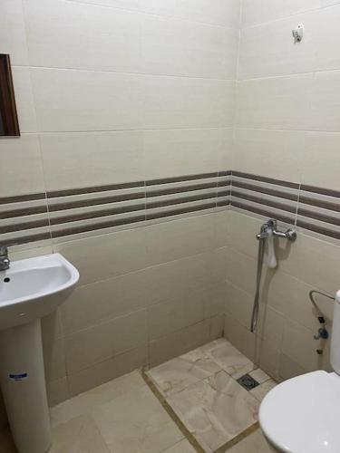a bathroom with a toilet and a sink at E Nice one bedroom apartement wifi in Fez