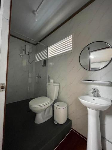 a bathroom with a toilet and a sink at Motel Ngọc Hiền in Pleiku
