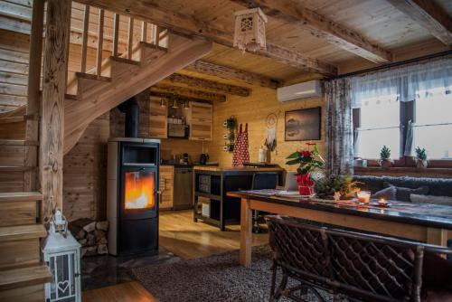 een keuken en een woonkamer met een houtkachel bij DOMEK KARMELOWY - Azyl Na Szwedach in Ruszelczyce
