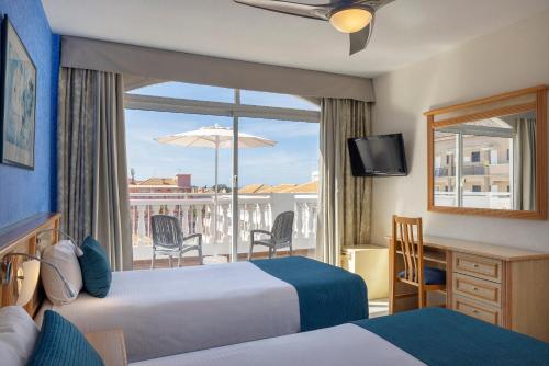 a hotel room with two beds and a balcony at whala!tenerife - Formerly Marola Portosin in Playa de las Americas