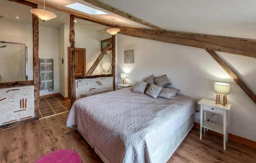 a bedroom with a large bed and a mirror at Beautiful Home In Armillac With House A Panoramic View in Armillac