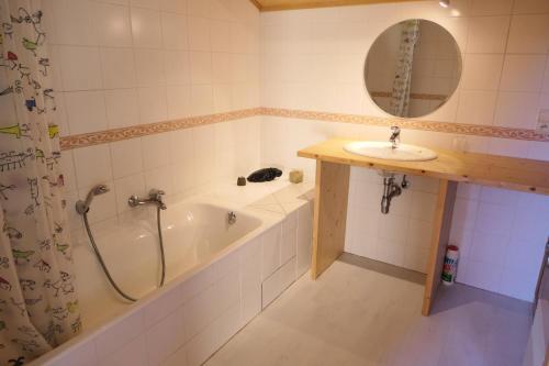 a bathroom with a bath tub and a sink at Chalet Granier - Chalets pour 6 Personnes 34 in Saint-Gervais-les-Bains