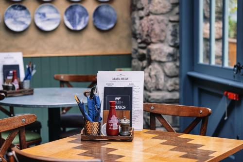 a wooden table with a box on top of it at The Bull and Townhouse, Beaumaris- The Inn Collection Group in Beaumaris