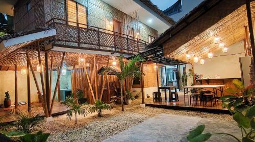 a building with a bunch of plants in a courtyard at Intoy's Place in Panglao