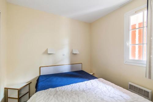 une chambre avec un lit et une fenêtre dans l'établissement Résidence le Hameau de Cap Esterel - maeva Home - Appartement 2 Pièces 7 Personnes - Confort MAE-5820, à Saint-Raphaël
