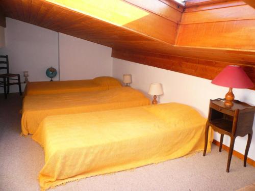 a bedroom with a bed and a table with a lamp at Résidence Les Cristaux Du Haut - Cristaux 51 MAE-5310 in Combloux