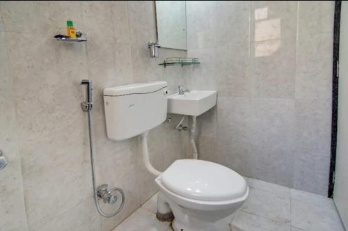 a bathroom with a toilet and a sink at ESTA EXPRESS,VIMAN NAGAR in Pune