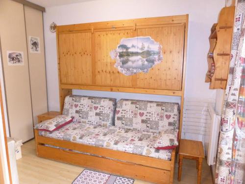 une chambre avec un lit avec une tête de lit en bois dans l'établissement Résidence Pierres Blanches - Pierres Blanches H579 MAE-5342, aux Contamines-Montjoie