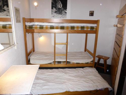 two bunk beds in a room with a bed at Résidence Le Brulaz - Studio pour 5 Personnes 50 in Les Contamines-Montjoie