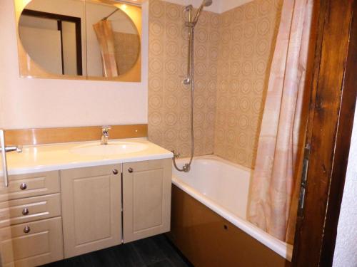 a bathroom with a sink and a tub and a shower at Résidence Le Brulaz - Studio pour 5 Personnes 50 in Les Contamines-Montjoie