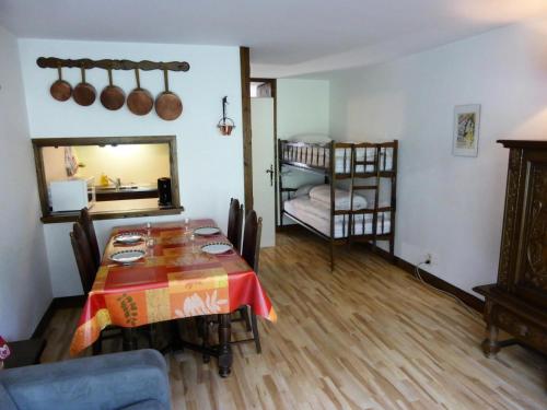 a living room with a table and a bunk bed at Résidence Bionnassay - Bionnassay B159 MAE-5357 in Les Contamines-Montjoie