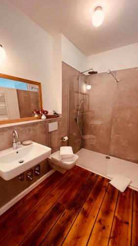 a bathroom with a toilet and a sink and a shower at Quartier Alte Schule Breese in Breese