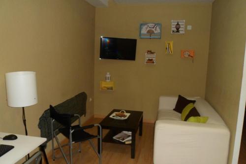 a living room with a couch and a table at Granada Old Town Hostel in Granada