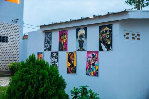 a group of paintings on the side of a building at The Shelter Abidjan in Abidjan