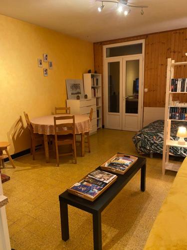 un salon avec une table et une salle à manger dans l'établissement maisonnette, à Aigrefeuille-dʼAunis