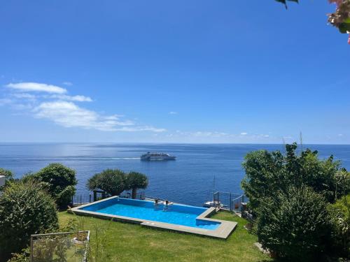 a swimming pool with a view of the ocean at Irlandas Villa Funchal Seaside Villas in Funchal