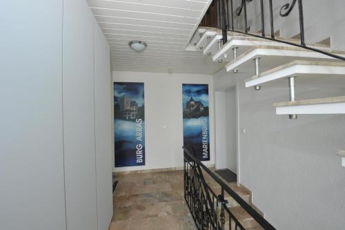 a hallway with stairs and posters on the walls at Ferienhaus Panorama Mosel in Reil