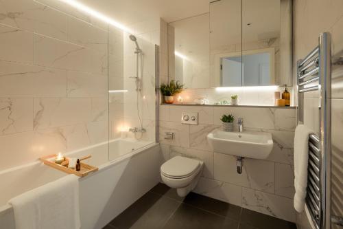 a white bathroom with a toilet and a sink at Luxury 2 bed Apartment Cherrywood Dublin 18 in Dublin