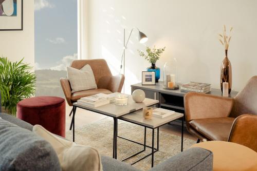 a living room with chairs and a coffee table at Luxury 2 bed Apartment Cherrywood Dublin 18 in Dublin
