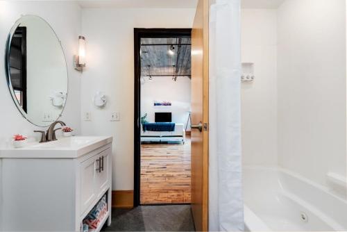a bathroom with a sink and a mirror at Stunning 1BR Adler Loft by CozySuites in Saint Louis