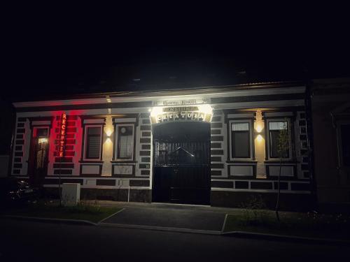 a house lit up at night with lights on it at Cetatuia in Râşnov