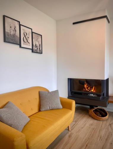 a living room with a couch and a fireplace at Alojamiento MAS EL CASTELL DEL BRULL in El Brull
