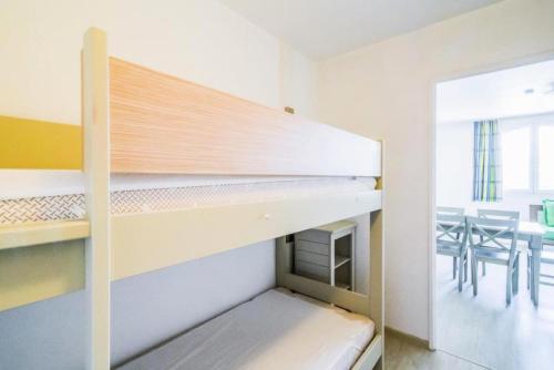 a bunk bed in a room with a table and chairs at Résidence Saint-Raphaël Valescure - maeva Home - 2 Pièces 6 Personnes Sélection MAE-4876 in Valescure