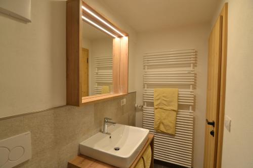 a bathroom with a sink and a mirror at SCHETERERHOF in San Candido