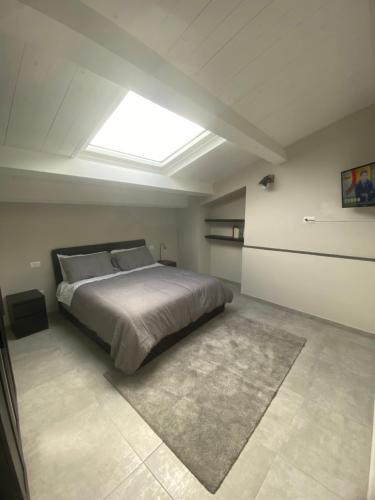 a bedroom with a large bed with a skylight at Huis Van Wittel in Caserta