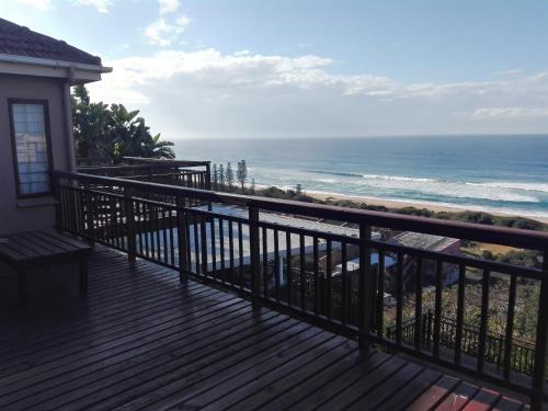 a balcony with a view of the ocean at Bayview Guest House in Amanzimtoti