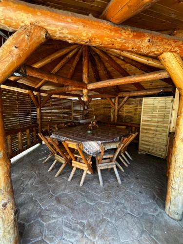 a wooden table and chairs in a hut at Cetatuia in Râşnov