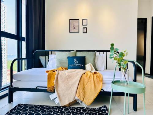 a bedroom with a bed with a glass table and a window at Cozy & Drive Urban Suite by WL in Jelutong