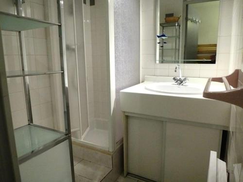 La salle de bains blanche est pourvue d'un lavabo et d'une douche. dans l'établissement Résidence Balcons De Bareges - 2 Pièces pour 5 Personnes 344, à Barèges
