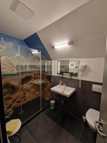 a bathroom with a sink and a shower at Hotel Restaurant Esser in Wegberg