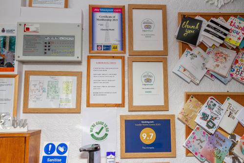 a wall with certificates and diplomas on it at The Almeria in Blackpool