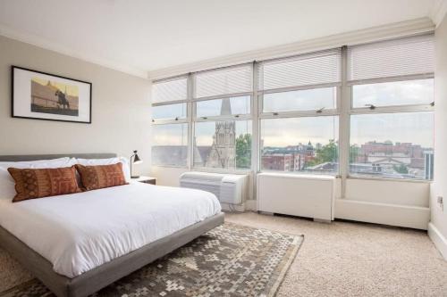 a bedroom with a bed and a large window at TWO 800 Tower CozySuites w skypool lounge 8FL in Louisville