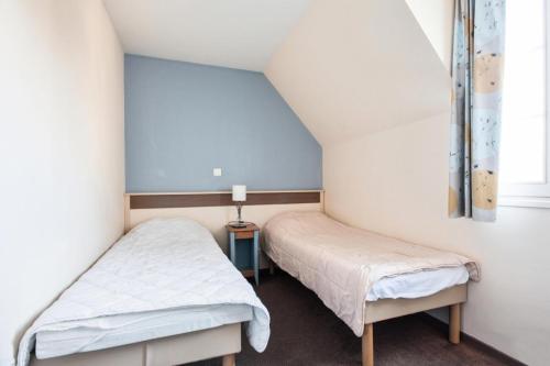 Ένα ή περισσότερα κρεβάτια σε δωμάτιο στο Les Maisons de Belle Dune - maeva Home - Maison 3 pièces 6 pers Sélection MAE-1398