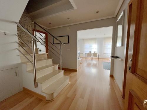 a staircase in a house with a living room at Dúplex Valle del Silencio in Ponferrada