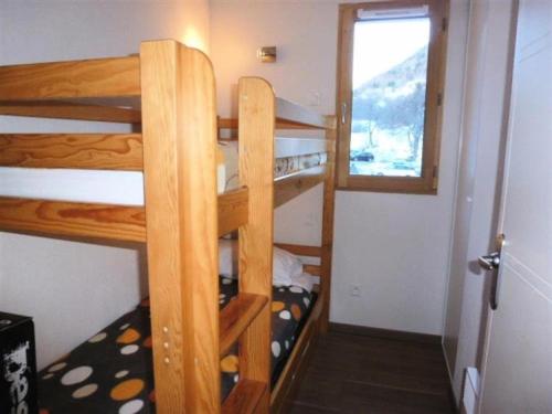 two bunk beds in a small room with a window at Résidence Bois De Marie - 4 Pièces pour 7 Personnes 564 in Barèges