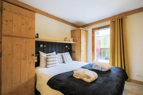 une chambre avec un grand lit avec des serviettes dessus dans l'établissement Résidence Les Arcs 1950 Le Village - maeva Home - Appartement 4 pièces 8 personnes - Prestige MAE-2160, à Bourg-Saint-Maurice