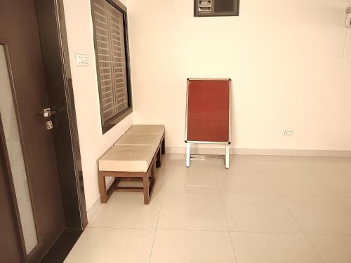 a room with a bench and a window and a chalkboard at Abu Inn, Mount Abu - The Luxury Boutique Stay in Mount Ābu